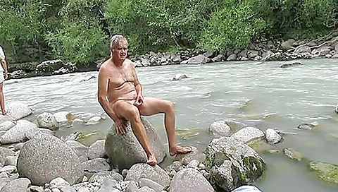 Horny milf relaxing in the river while she is getting filmed